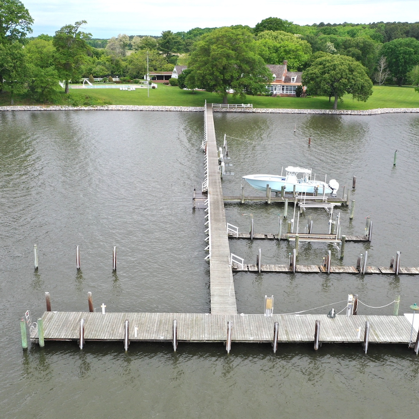 a drone image of the dock, boat, and home at Bachelors Hope in Chestertown