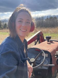 Sara Starman, on the tractor at Tavern Creek Farm.